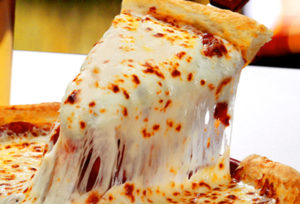 an image of a cheese pizza and a slice is being pulled up creating long strand of mozzarella cheese