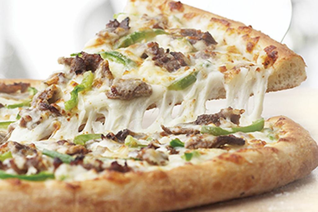 An image of a philly cheese steak pizza, it looks very tasty with the slices of steak, onions and green peppers NUMMY! 